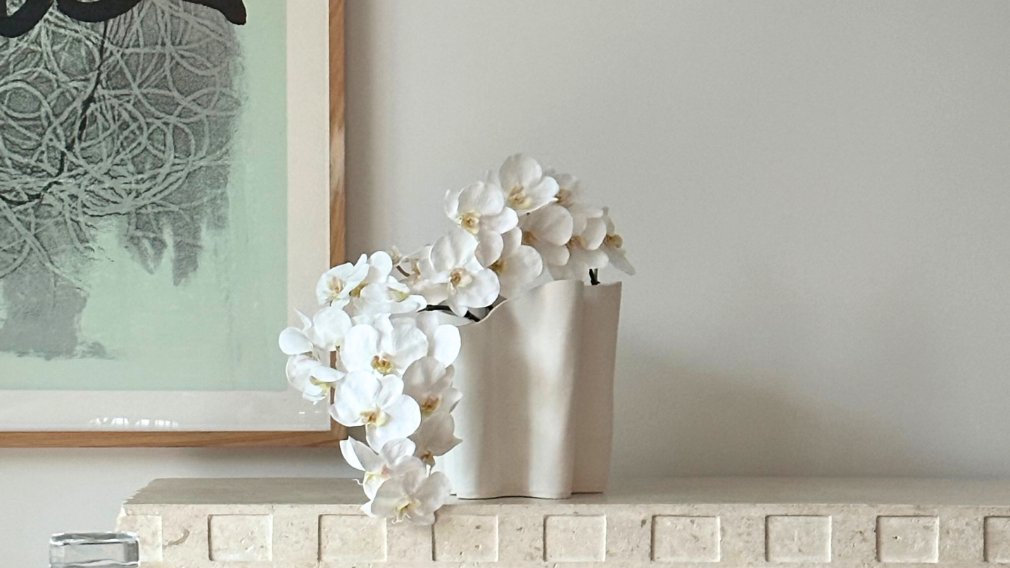 Elegant custom orchid arrangement styled in a sophisticated ceramic vase for a timeless, luxurious touch.